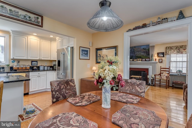 336 Miller St, Winchester, VA 22601 - dining room featuring light wood finished floors and a fireplace