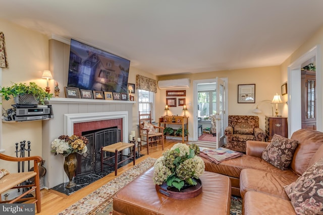 336 Miller St, Winchester, VA 22601 - living room featuring a wall mounted air conditioner, wood finished floors, and a brick fireplace