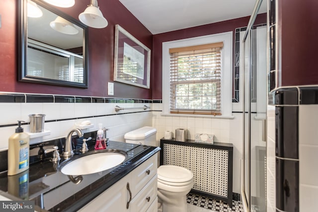 336 Miller St, Winchester, VA 22601 - full bath featuring tile walls, a shower stall, toilet, vanity, and a wainscoted wall