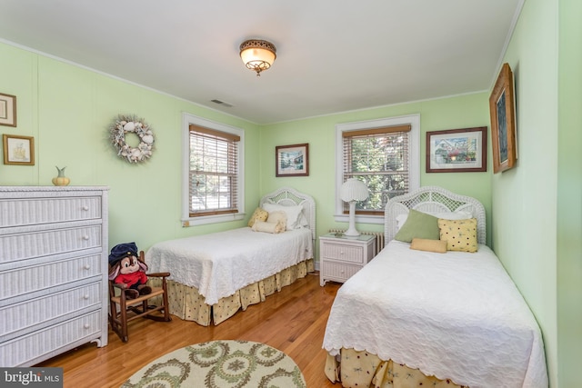 336 Miller St, Winchester, VA 22601 - bedroom with multiple windows, wood finished floors, and ornamental molding
