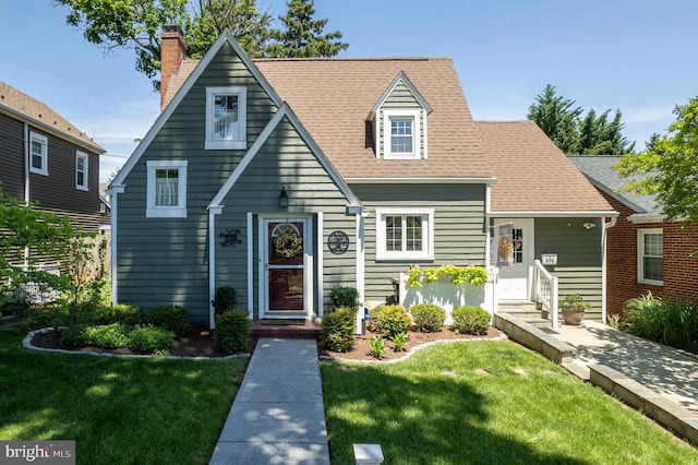 336 Miller St, Winchester, VA 22601 - view of front of home with a front yard, roof with shingles, and a chimney