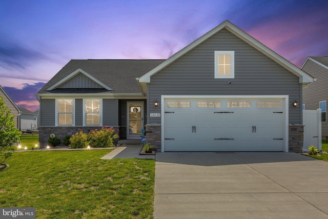 12037 Angora Dr, King George, VA 22485 - view of front of property featuring stone siding, concrete driveway, a lawn, an attached garage, and a shingled roof