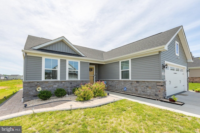 12037 Angora Dr, King George, VA 22485 - view of front facade featuring stone siding, concrete driveway, board and batten siding, and roof with shingles