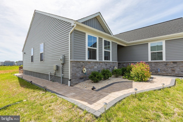 12037 Angora Dr, King George, VA 22485 - view of property exterior with a lawn, board and batten siding, and stone siding