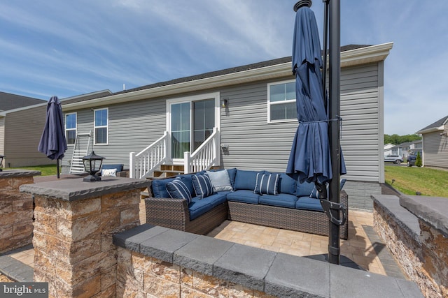 12037 Angora Dr, King George, VA 22485 - back of property with outdoor lounge area, a patio area, and entry steps