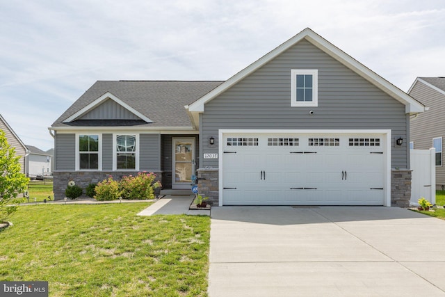 12037 Angora Dr, King George, VA 22485 - view of front of house with stone siding, driveway, a front lawn, a shingled roof, and board and batten siding