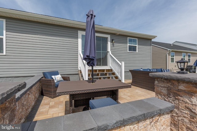 12037 Angora Dr, King George, VA 22485 - rear view of house featuring entry steps, a patio area, and an outdoor living space