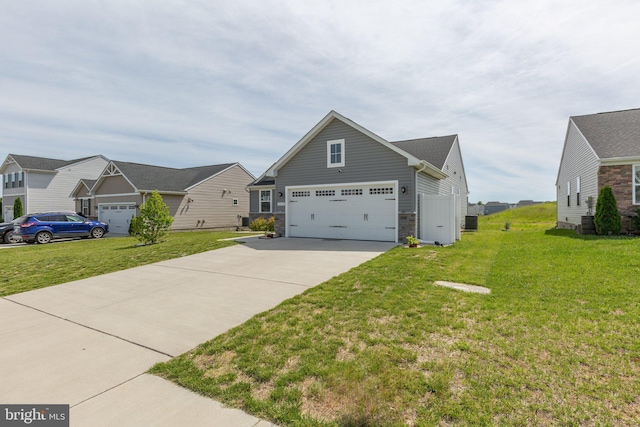 12037 Angora Dr, King George, VA 22485 - view of front of house featuring concrete driveway, stone siding, and a front lawn
