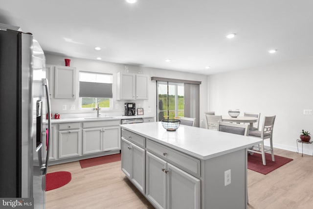 12037 Angora Dr, King George, VA 22485 - kitchen with stainless steel refrigerator with ice dispenser, light wood-style flooring, a sink, a center island, and light countertops