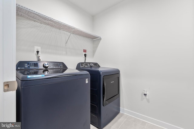12037 Angora Dr, King George, VA 22485 - washroom featuring washer and clothes dryer, baseboards, and light tile patterned floors