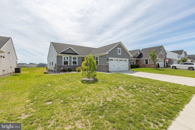 12037 Angora Dr, King George, VA 22485 - view of front of home featuring central AC, stone siding, concrete driveway, a front lawn, and an attached garage
