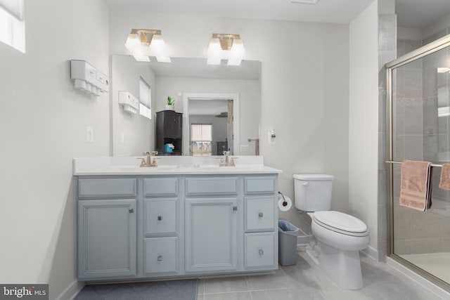12037 Angora Dr, King George, VA 22485 - full bathroom featuring toilet, a stall shower, double vanity, baseboards, and tile patterned flooring
