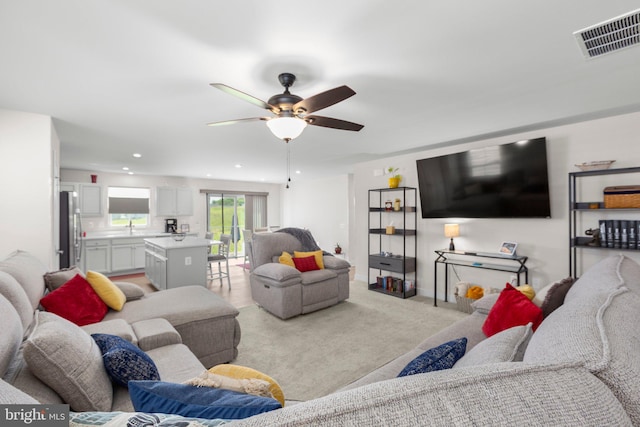12037 Angora Dr, King George, VA 22485 - living room featuring a ceiling fan, light colored carpet, and recessed lighting