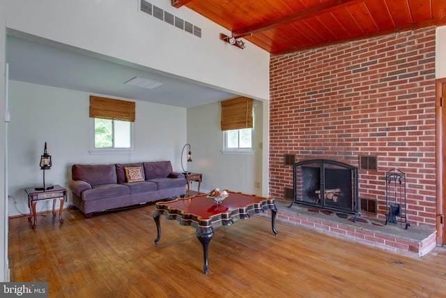 25 Panorama Dr, Oxon Hill, MD 20745 - living area featuring healthy amount of natural light, wood finished floors, wood ceiling with exposed beams, a wood stove, and a fireplace