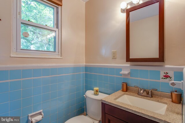 25 Panorama Dr, Oxon Hill, MD 20745 - half bath with a wainscoted wall, toilet, vanity, and tile walls