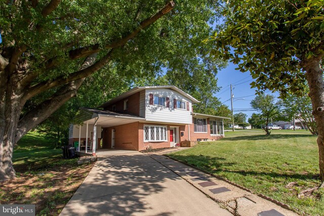 25 Panorama Dr, Oxon Hill, MD 20745 - tri-level home with brick siding, driveway, a front yard, and an attached carport