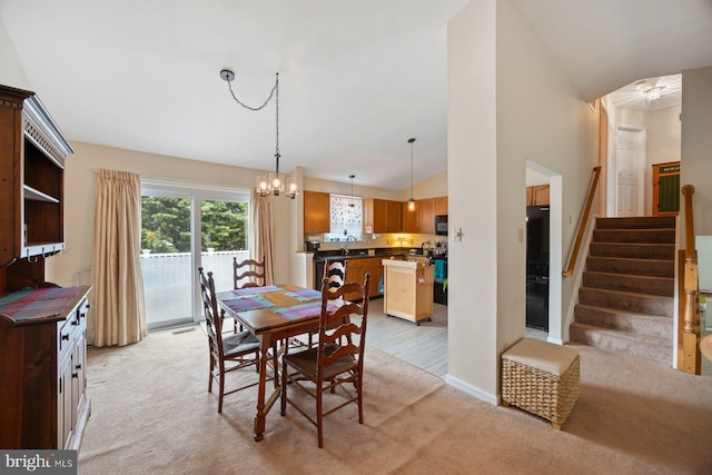 21 Bancroft St, Taneytown, MD 21787 - dining space featuring light colored carpet, lofted ceiling, a chandelier, and stairs