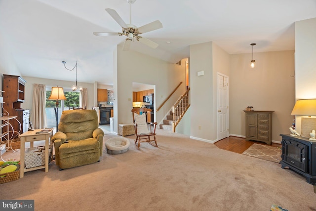 21 Bancroft St, Taneytown, MD 21787 - living room with carpet floors, a wood stove, stairway, ceiling fan, and baseboards