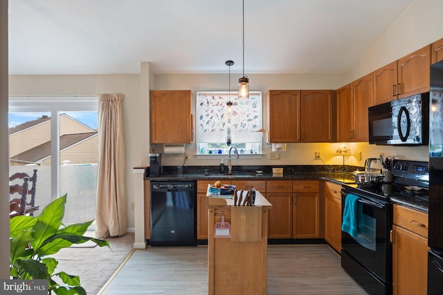 21 Bancroft St, Taneytown, MD 21787 - kitchen featuring black appliances, a sink, light wood-style floors, hanging light fixtures, and a center island