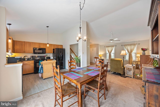 21 Bancroft St, Taneytown, MD 21787 - dining space featuring lofted ceiling, ceiling fan, light carpet, baseboards, and stairway
