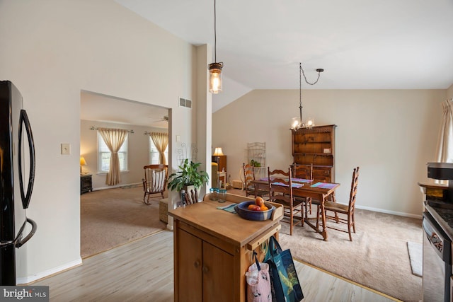 21 Bancroft St, Taneytown, MD 21787 - dining room with light wood-style floors, a chandelier, lofted ceiling, light carpet, and baseboards