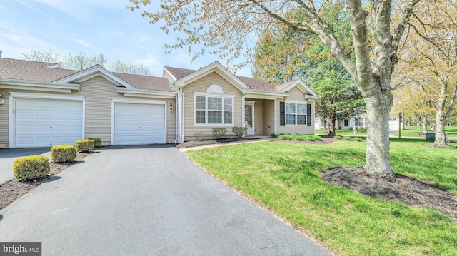 628 E Regency Dr, Absecon, NJ 08205 - single story home featuring a garage, asphalt driveway, and a front yard