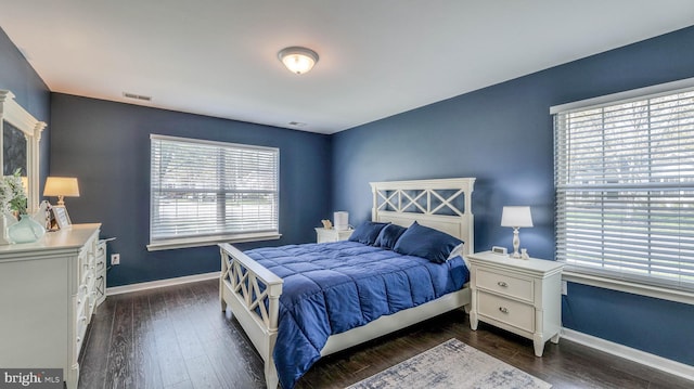628 E Regency Dr, Absecon, NJ 08205 - bedroom with multiple windows, baseboards, and dark wood-type flooring