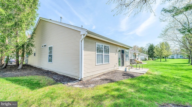 628 E Regency Dr, Absecon, NJ 08205 - view of side of home with a patio area and a lawn