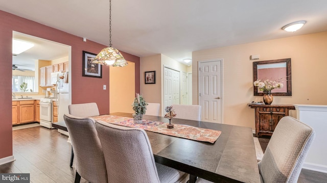 628 E Regency Dr, Absecon, NJ 08205 - dining area featuring dark wood-type flooring, a ceiling fan, and baseboards