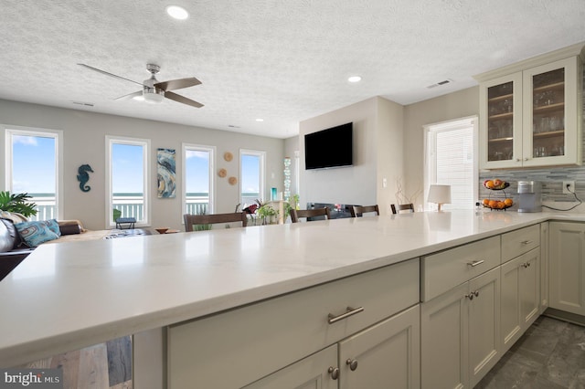 106 Lighthouse Dr, Hampton, VA 23664 - kitchen featuring open floor plan, a peninsula, ceiling fan, glass insert cabinets, and recessed lighting