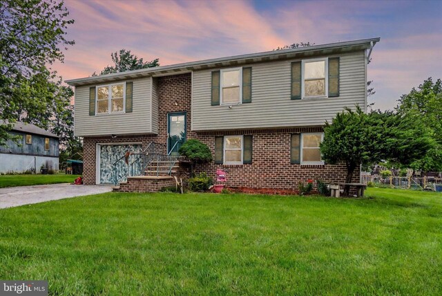 3111 Jessica Rd, Dover, PA 17315 - split foyer home featuring brick siding, driveway, a yard, and a garage