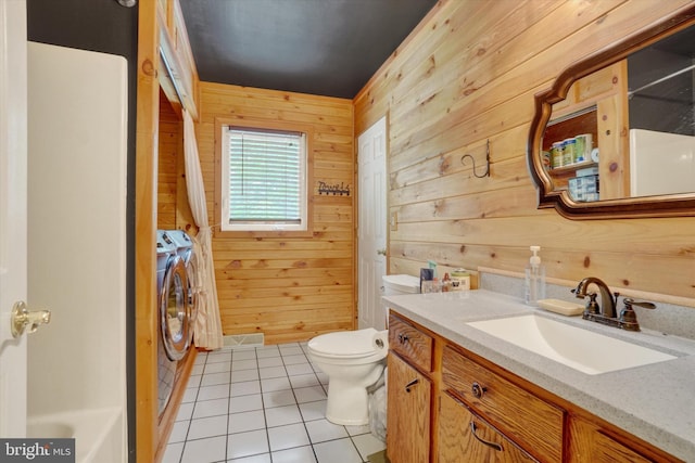 3111 Jessica Rd, Dover, PA 17315 - bathroom featuring washer and dryer, wooden walls, toilet, tile patterned floors, and vanity
