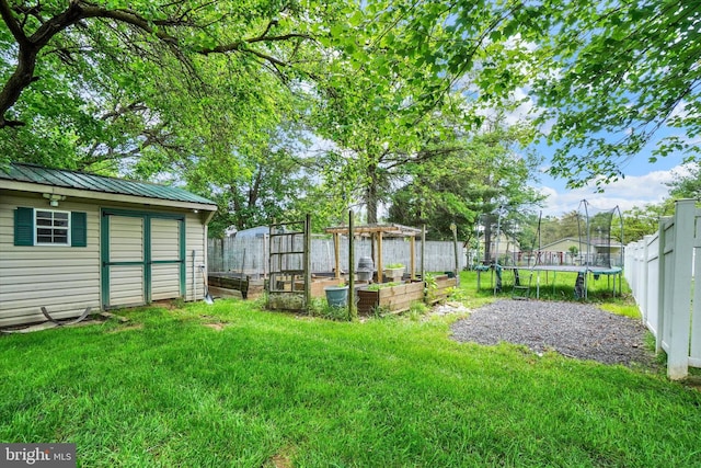 3111 Jessica Rd, Dover, PA 17315 - view of yard featuring a trampoline, a garden, and an outbuilding