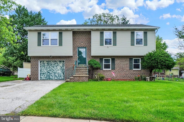 3111 Jessica Rd, Dover, PA 17315 - split foyer home with an attached garage, a front lawn, driveway, and brick siding