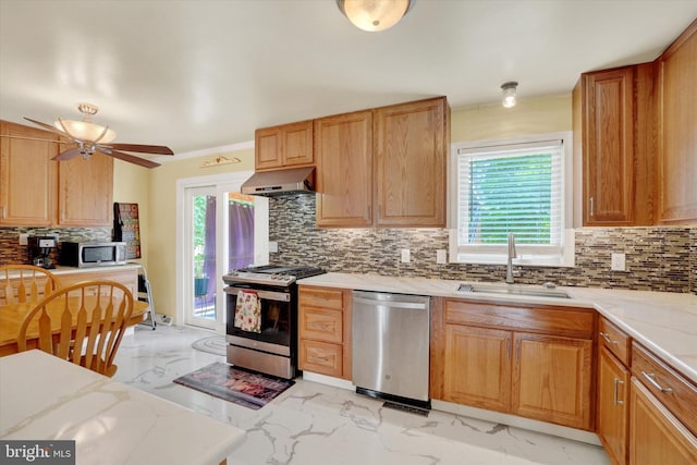 3111 Jessica Rd, Dover, PA 17315 - kitchen featuring appliances with stainless steel finishes, light marble finish flooring, under cabinet range hood, a sink, and plenty of natural light
