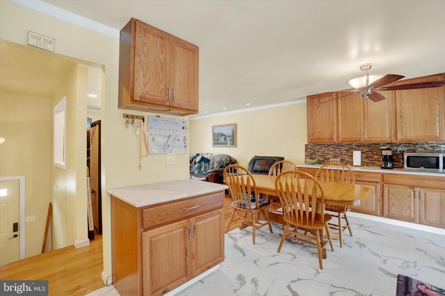 3111 Jessica Rd, Dover, PA 17315 - kitchen featuring stainless steel microwave, light countertops, tasteful backsplash, light marble finish floors, and ceiling fan