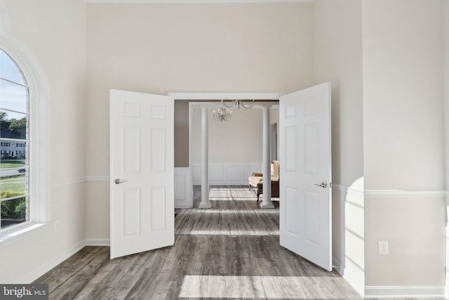 11202 King Gallahan Ct, Clinton, MD 20735 - unfurnished bedroom featuring wood finished floors, multiple windows, a chandelier, and a high ceiling