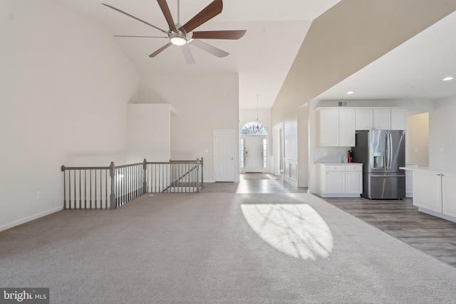 11202 King Gallahan Ct, Clinton, MD 20735 - unfurnished living room with high vaulted ceiling, ceiling fan, baseboards, a chandelier, and recessed lighting