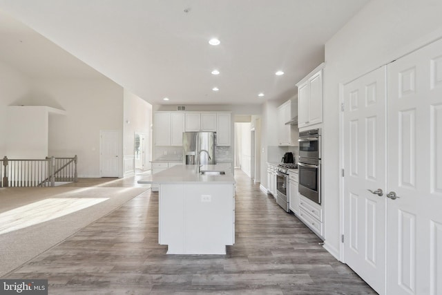 11202 King Gallahan Ct, Clinton, MD 20735 - kitchen featuring stainless steel appliances, recessed lighting, white cabinets, tasteful backsplash, and a kitchen island with sink