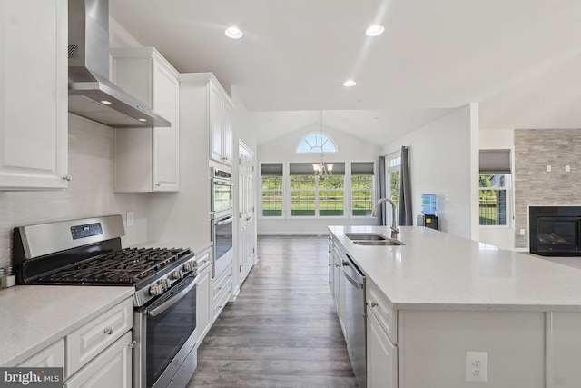11202 King Gallahan Ct, Clinton, MD 20735 - kitchen with appliances with stainless steel finishes, wall chimney exhaust hood, a sink, a center island with sink, and white cabinetry