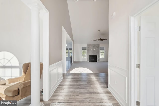 11202 King Gallahan Ct, Clinton, MD 20735 - hallway featuring a decorative wall, wainscoting, wood finished floors, decorative columns, and a high ceiling
