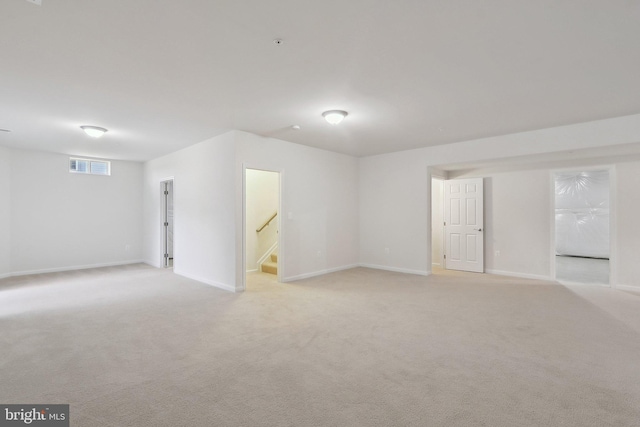 11202 King Gallahan Ct, Clinton, MD 20735 - empty room with light colored carpet, baseboards, and stairs