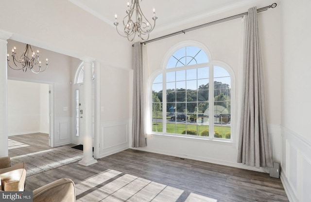 11202 King Gallahan Ct, Clinton, MD 20735 - entryway with a chandelier, plenty of natural light, wainscoting, wood finished floors, and a decorative wall