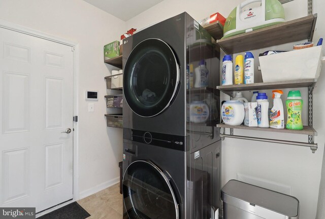 11202 King Gallahan Ct, Clinton, MD 20735 - laundry room with stacked washer / drying machine, tile patterned flooring, and baseboards