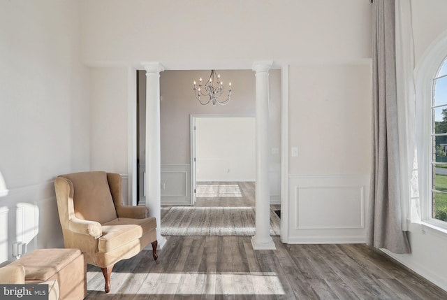 11202 King Gallahan Ct, Clinton, MD 20735 - sitting room with a chandelier, a wainscoted wall, a decorative wall, dark wood finished floors, and ornate columns