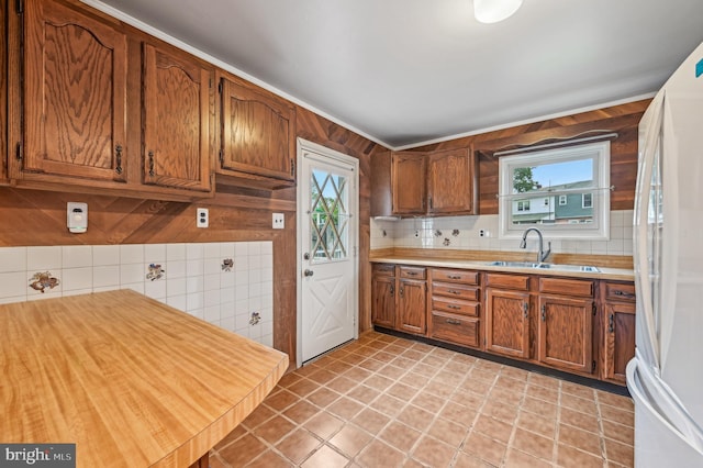 225 Dunlap Rd, Pasadena, MD 21122 - kitchen featuring freestanding refrigerator, a sink, brown cabinets, and plenty of natural light