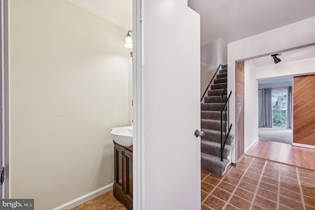225 Dunlap Rd, Pasadena, MD 21122 - staircase with tile patterned floors, crown molding, and baseboards