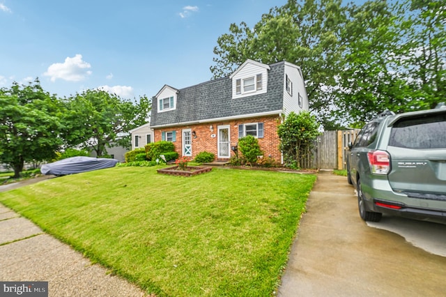 225 Dunlap Rd, Pasadena, MD 21122 - colonial inspired home with brick siding, a gambrel roof, a shingled roof, and concrete driveway