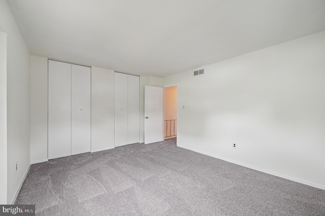 225 Dunlap Rd, Pasadena, MD 21122 - unfurnished bedroom with multiple closets and carpet flooring