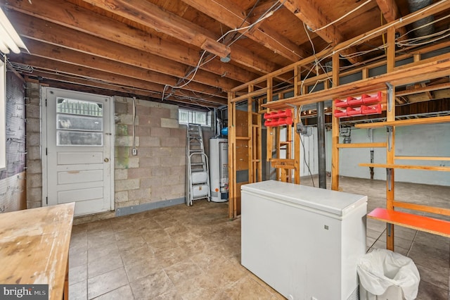 225 Dunlap Rd, Pasadena, MD 21122 - basement with white refrigerator, gas water heater, and healthy amount of natural light